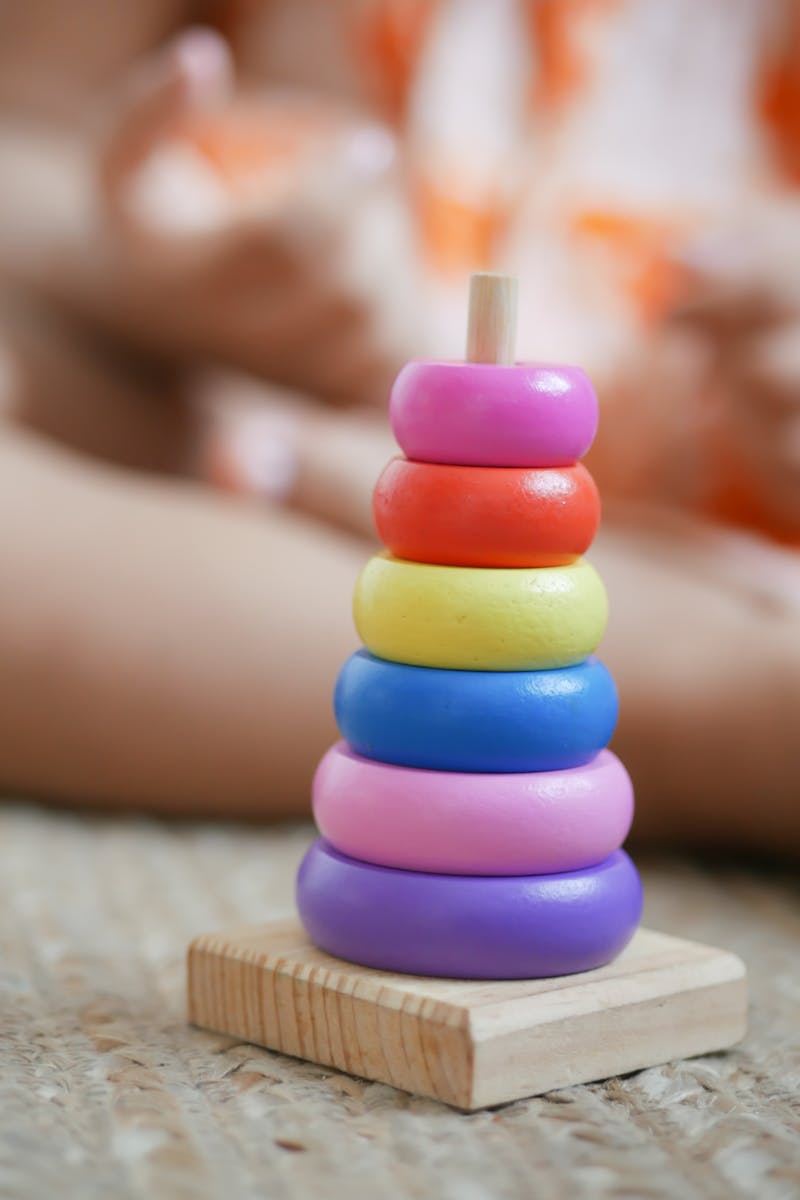 Home_Evolukit_WIP Vibrant wooden stacking rings toy for child development and learning.
